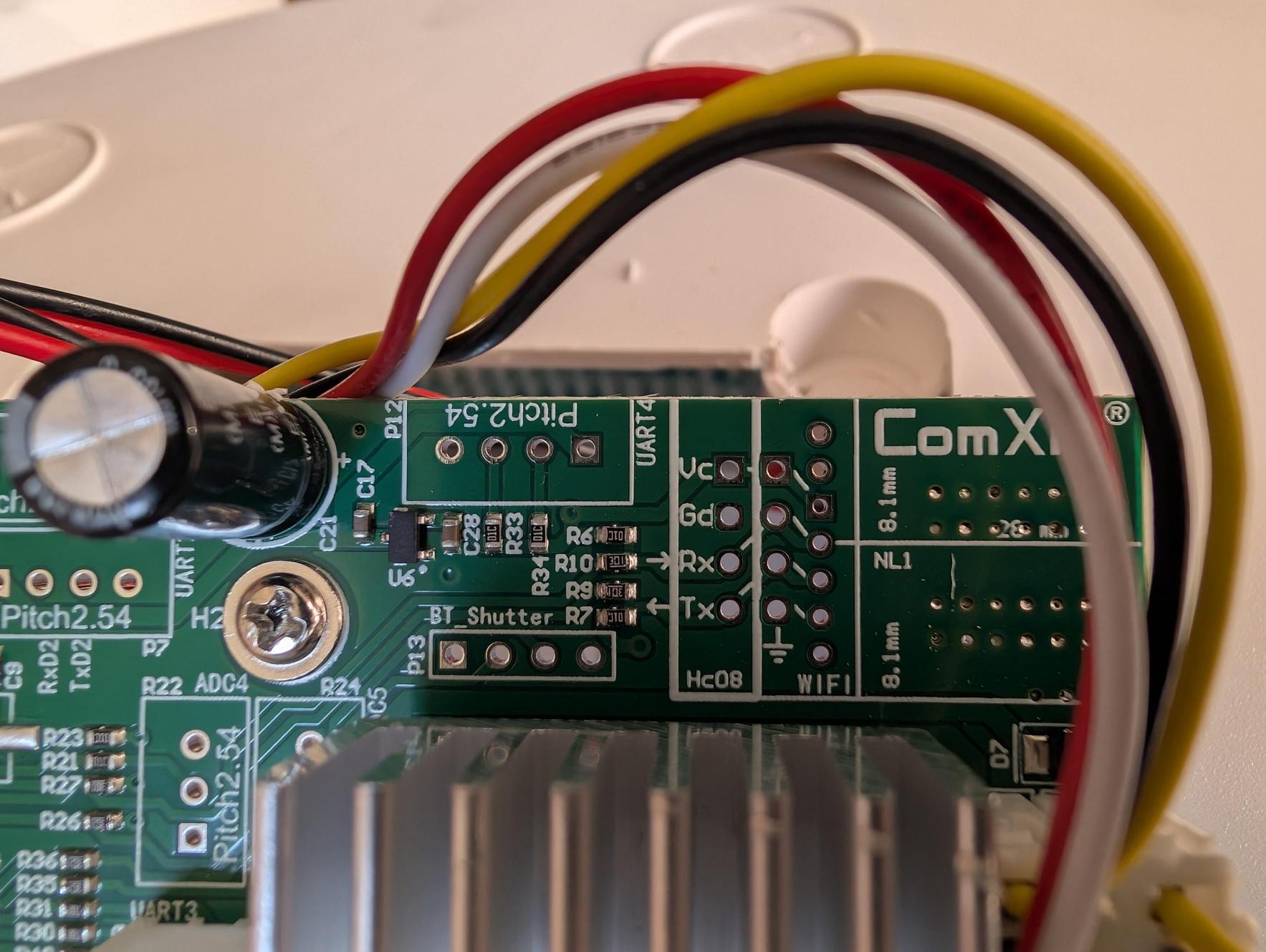 June 23: Close-up of the UART4 header. Four pads labeled Vc, Gd, Rx, Tx. Yellow tape applied during wiring. This was the target of the serial interception attempt — which produced no traffic.